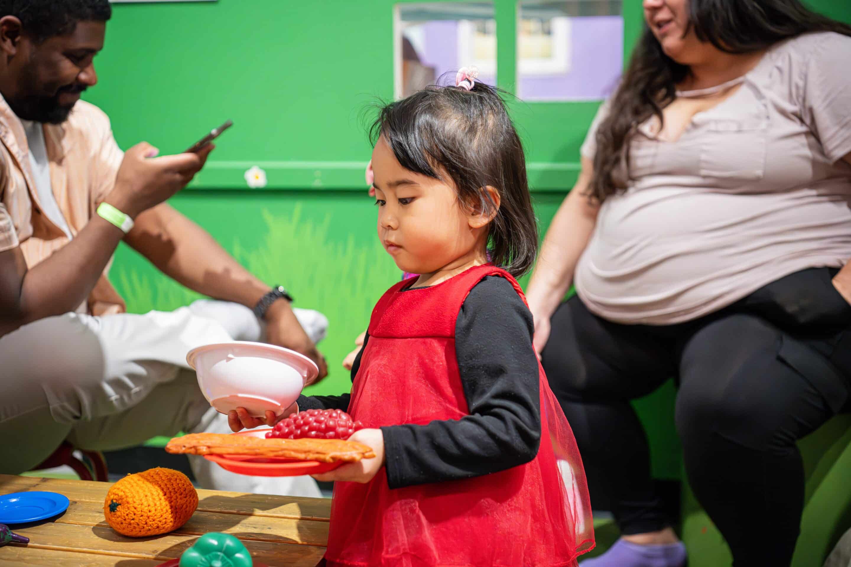 Girl holding plastic bowl and plate